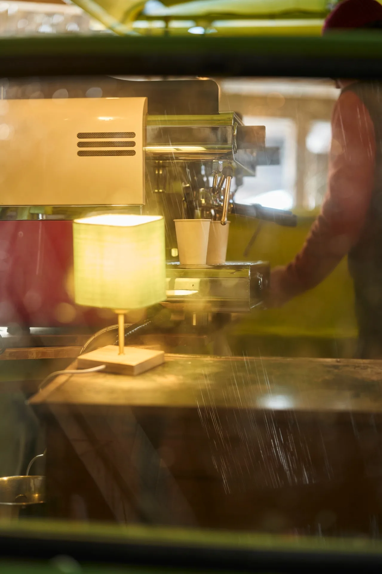 Warm lamp glow next to the espresso machine