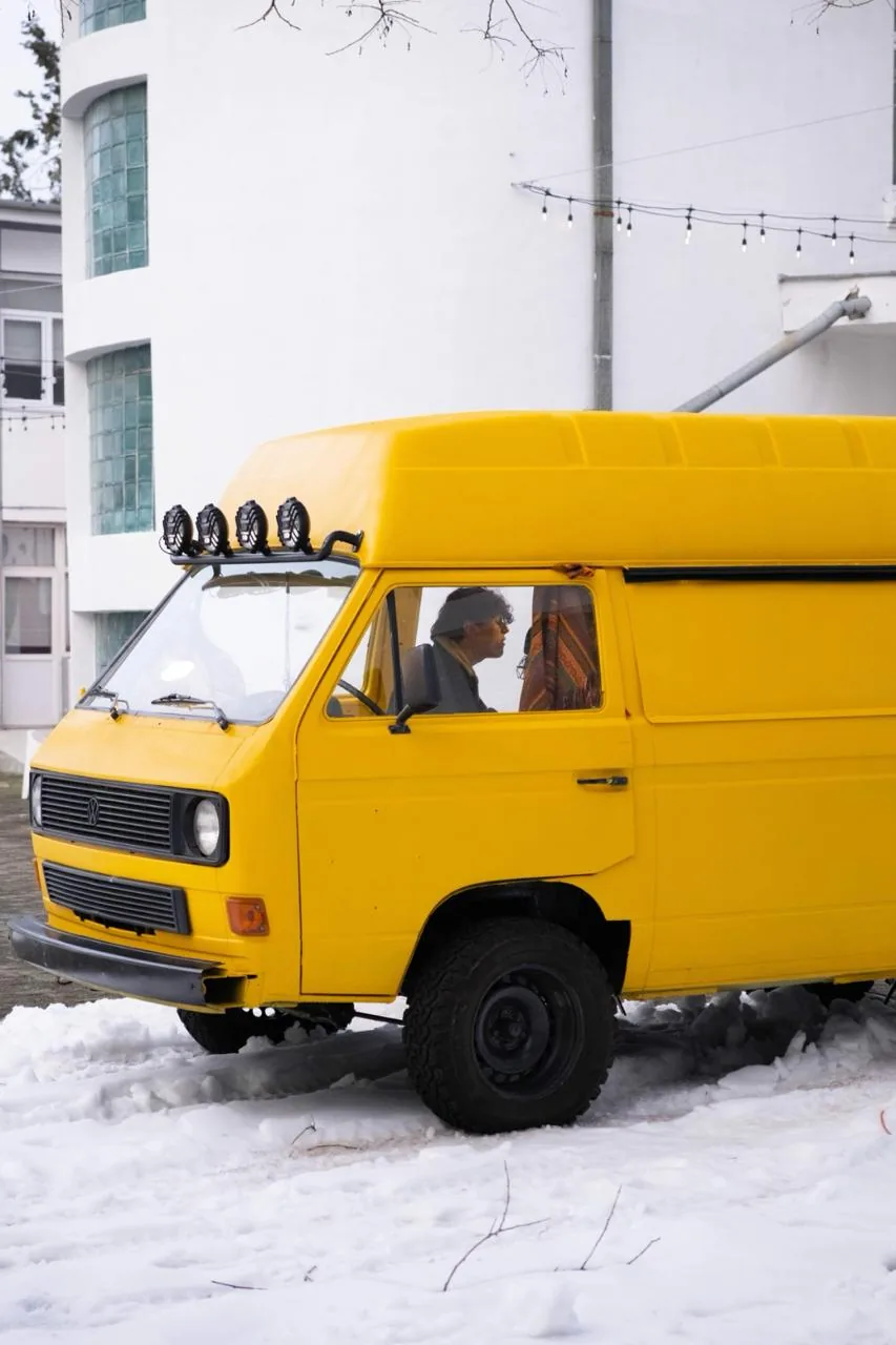 Yellow VW T3 van parked in the snow